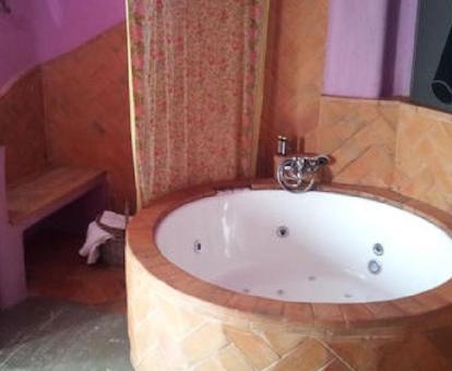 Bañera de hidromasaje circular que se encuentra en el baño de la suite con jacuzzi y balcón