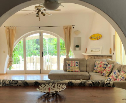 Foto de Villa Micasa donde se observa la sala de estar interior y la puerta que da hacia la piscina de la villa