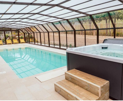 Foto de la piscina cubierta climatizada y la bañera de hidromasaje